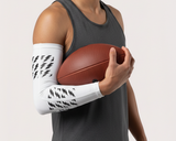 Man holding a basketball with a white arm sleeve on a plain background