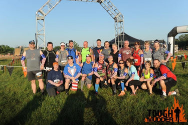 Team of athletes wearing american flag arm sleeves at a sports event.